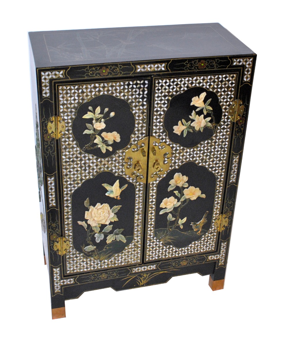 A 20th century Japanese black lacquered side cabinet, with applied bird and floral decoration,