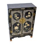 A 20th century Japanese black lacquered side cabinet, with applied bird and floral decoration,