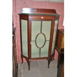 An Edwardian mahogany and inlaid display cabinet with astragal glazed central door above four