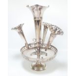 An electroplated centrepiece with large central epergne and three further detachable epergnes above