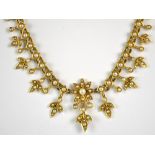 A late 19th/early 20th century 15ct yellow gold and half seed pearl necklace with central star