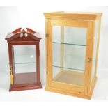 A pine glazed table top display cabinet, height 66cm, and a smaller mahogany example (2).