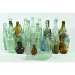 A collection of vintage glass bottles, some with local interest, including pharmacy, water, beer,