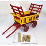 A large scratch built wooden toy hay wagon with horse shafts,