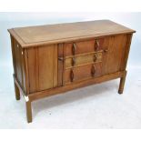 An early 20th century oak sideboard with three central short drawers flanked by twin cupboard doors