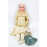 An early 20th century Armand Marseille bisque headed doll with open brown glass eyes,