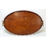 An Edwardian mahogany and inlaid oval tray with brass handles,