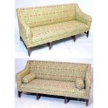 A near pair of George III mahogany and upholstered three seater settees with downswept arms and