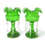 A pair of Victorian green glass table lustres, each with six prisms and hand painted decoration,