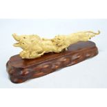 A Japanese Meiji period carved group depicting a tiger attacking two boars, unmarked, length 26cm,