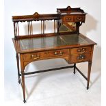 An Edwardian mahogany and inlaid desk with two small drawers above mirrored back to one side of the
