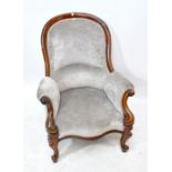 A Victorian mahogany hoop back easy armchair upholstered in grey velvet with scrolled arms and