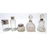 Four variously hallmarked silver mounted clear cut glass scent bottles to include a bell shaped