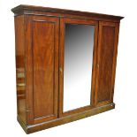 An Edwardian mahogany wardrobe with moulded cornice above central mirror flanked by doors,