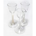 Three Georgian wine glasses with air twist stems, height 15cm, 14.5cm and 14cm (3).