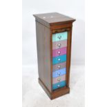 An early 20th century oak tambour fronted filing cabinet now set with eight multi-coloured painted