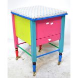 A painted sewing basket/stool with hinged padded top,