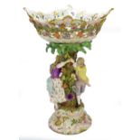 A large circa 1900 Meissen porcelain centrepiece modelled as a couple around a floral encrusted