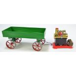 A Mamod Stationary Steam Engine (lacking box and accessories) and a trailer in green livery