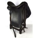 An approx 19" black dressage saddle, made by Frank Baines.