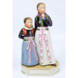 ROYAL COPENHAGEN; a painted figure group of two young female figures,