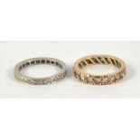 A yellow full eternity ring, size L 1/2 and a further white metal example, size M (2).