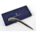 MASERATI; a factory issued paper knife in original box, chromium plated with engraved Maserati logo.