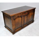 A reproduction oak coffer with triple panelled front.