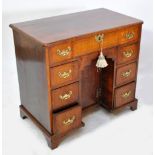 An 18th century walnut kneehole pedestal desk,