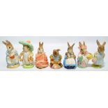 Seven Royal Albert Beatrix Potter character figures including 'Mr Rabbit', 'Mrs Rabbit Cooking',