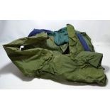 A collection of waterproof clothing, including green waterproof overalls.