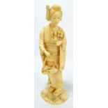 A Japanese Meiji period carved ivory okimono depicting a young woman in kimono with flower basket,