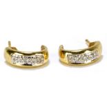 A pair of 9ct yellow gold and diamond set half hoop ear studs.