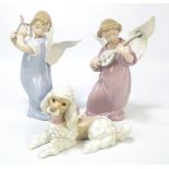 A pair of Lladro figures of angels, one playing a lyre and one playing a lute,