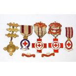 Four early 20th century enamelled British Red Cross Society medallions with ribbons,