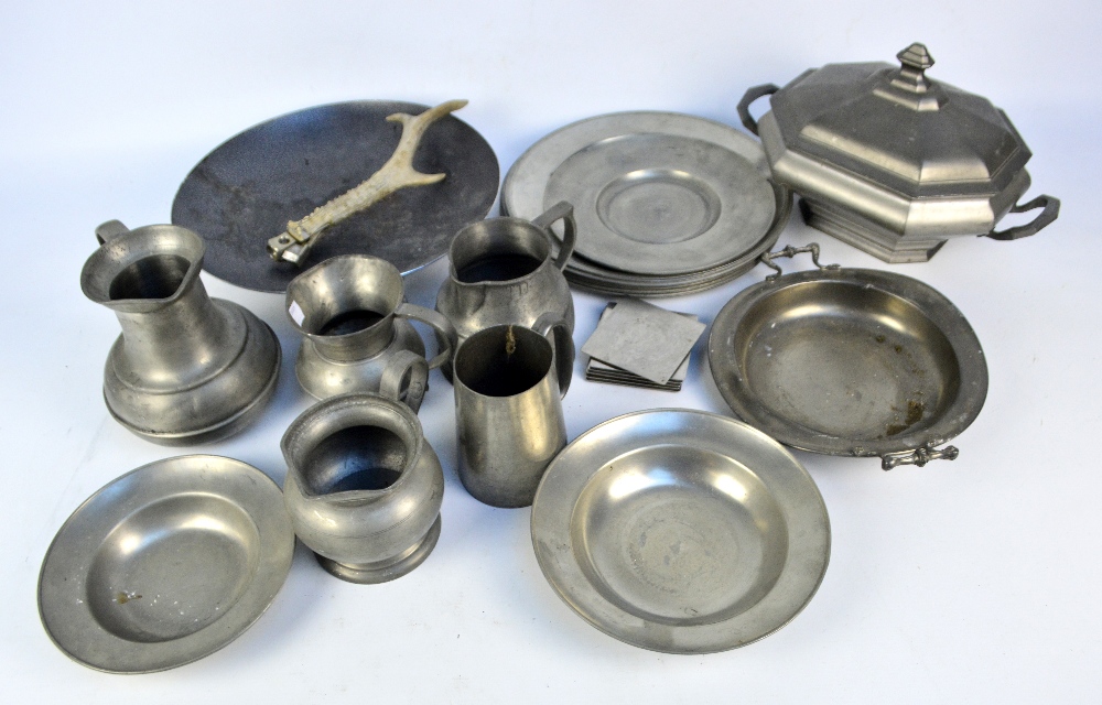 A group of pewter items including a set of six plates, a tureen with cover, and jugs,