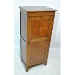 An early 20th century oak hall robe with hinged top (af) above single door on ogee bracket feet,