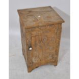 A square topped pine cupboard enclosing single drawer with highly stylised carved floral decoration,