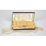 A cultured pearl two-strand necklace with silver and marcasite set clasp, length 65cm.