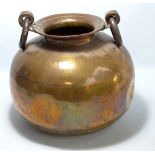 A large copper and brass globular pot with twin ring handles and part hammered body, height 37cm.