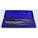 A cased three piece antler handled steel bladed carving set with hallmarked silver collars,