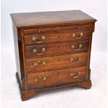 A George III oak chest with brushing slide above four long drawers, raised on bracket feet,