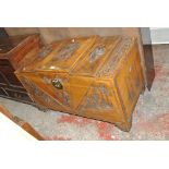 A 20th century Chinese camphorwood chest with stepped hinged lid carved with architectural