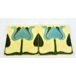 A pair of Arts and Crafts English tiles in the form of stylised flowers, each tile 15 x 15cm.