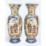 A pair of large 19th century Chinese porcelain Famille Rose opposing baluster vases painted in