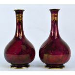 A pair of Losol Ware bottle vases with gilt decoration on a marbled pink ground, height 27cm.