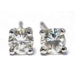 A pair of 9ct white gold diamond ear studs, combined 0.