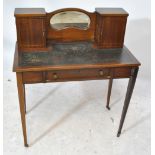 An Edwardian mahogany bonheur du jour with leather inset top and kidney shaped mirror,