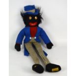 A Merrythought Golly doll in blue coat and hat with pinstripe trousers,