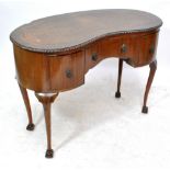 A reproduction mahogany kidney shaped desk with leather inset top above central drawer flanked by